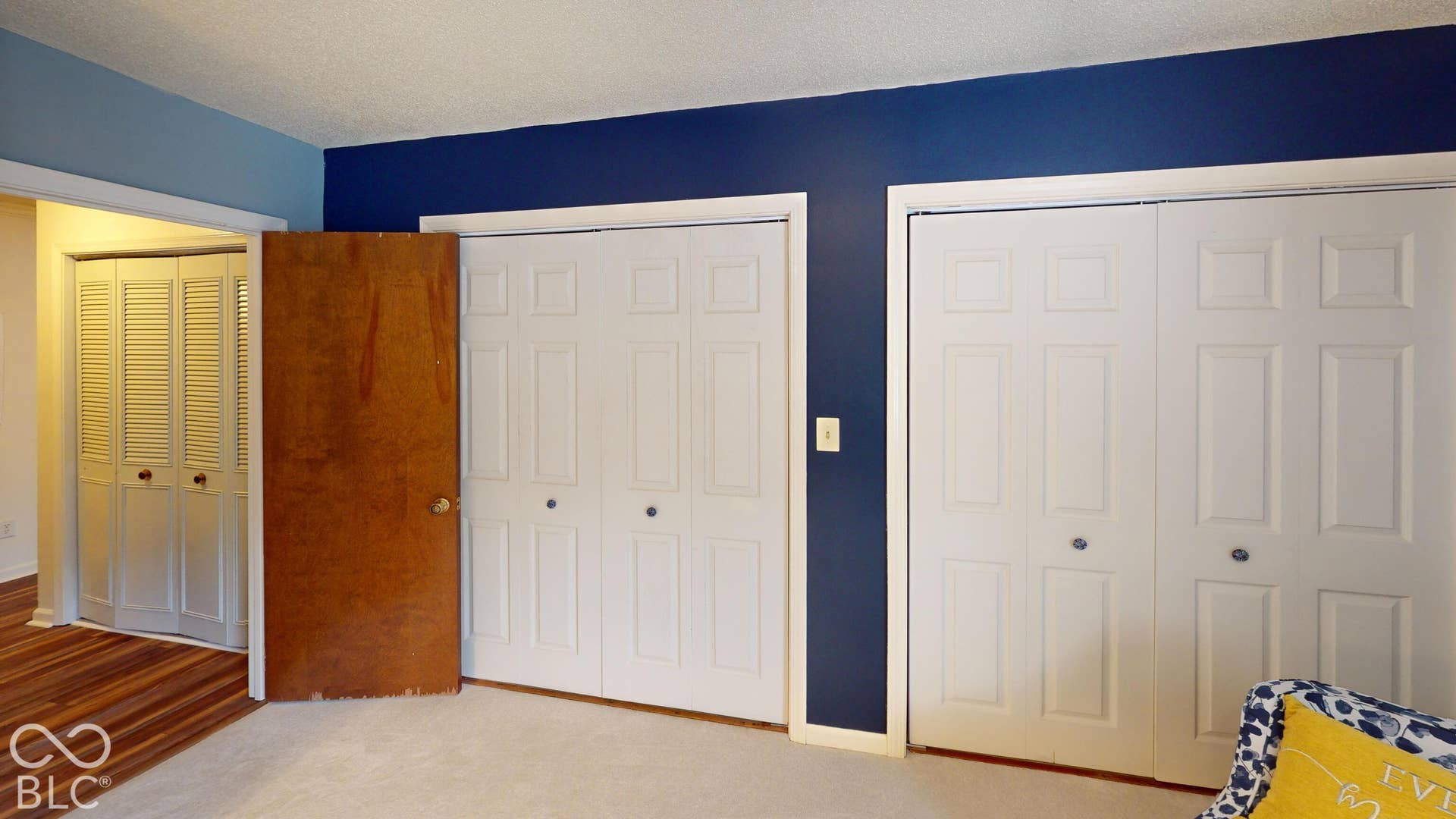 201 Bluffs Circle, Noblesville, IN 46062 BEDROOM #2 | Dual bi-fold closet doors with white paneling and round knobs