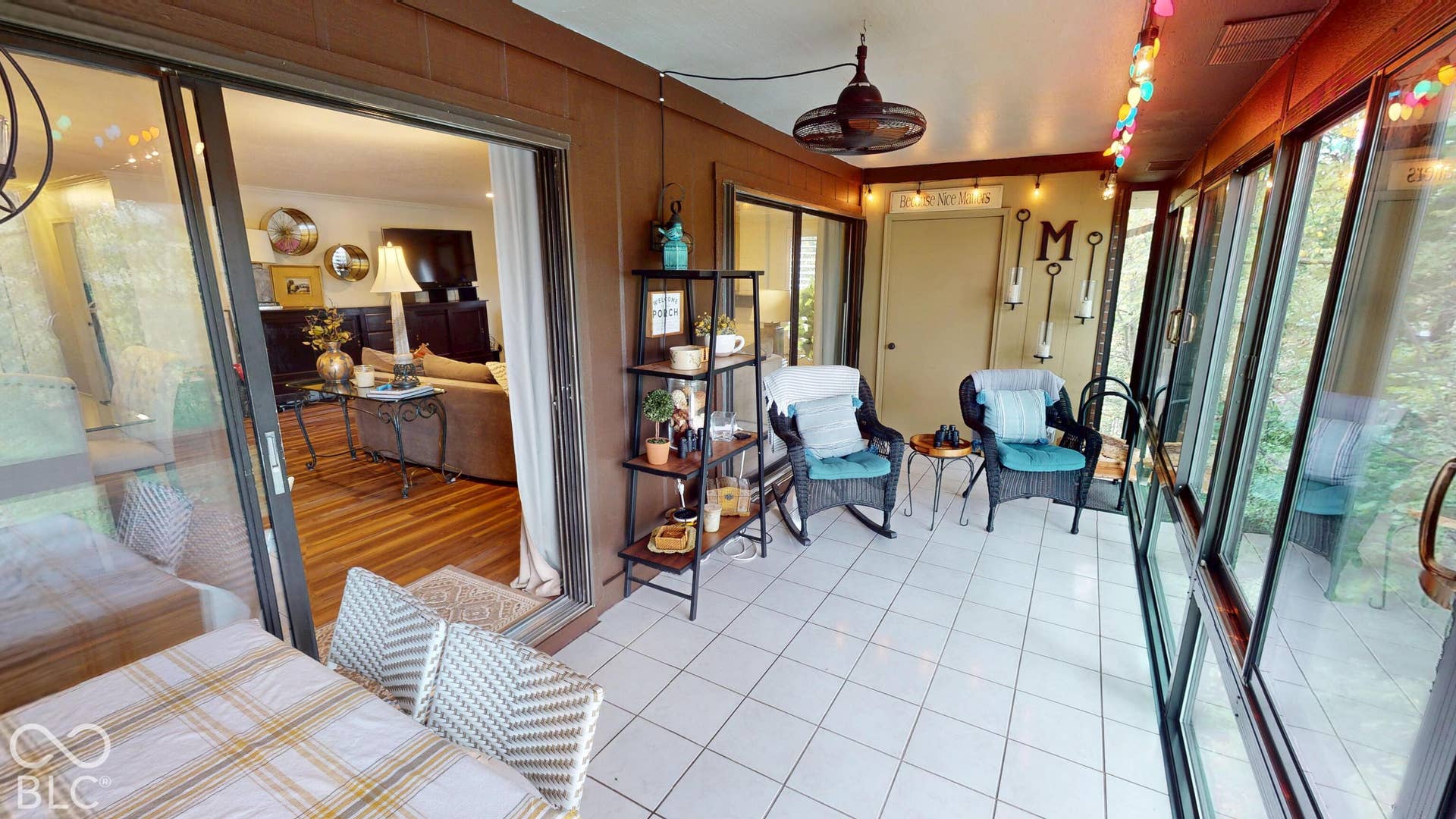 201 Bluffs Circle, Noblesville, IN 46062 Enclosed porch with large windows, white tile flooring, and a ceiling fan