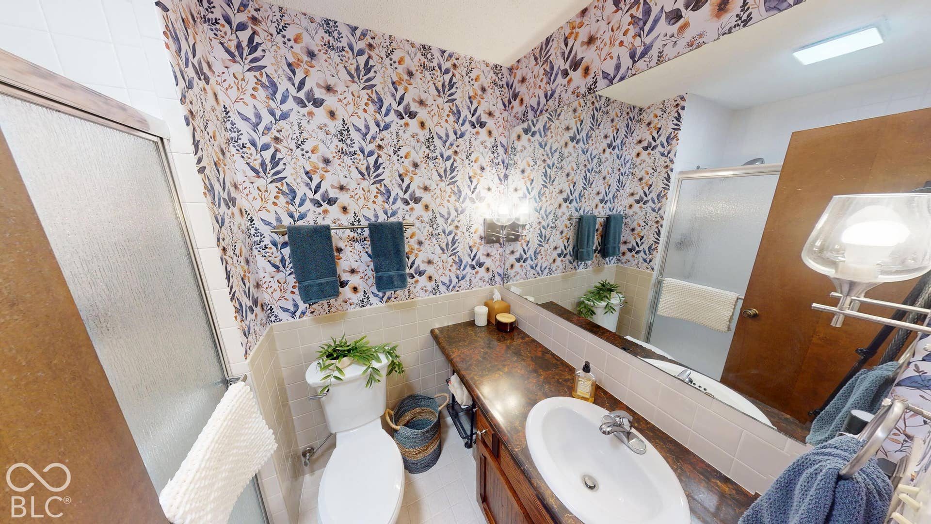 201 Bluffs Circle, Noblesville, IN 46062 Vanity with an integrated sink, polished chrome faucet, and a large wall-mounted mirror
