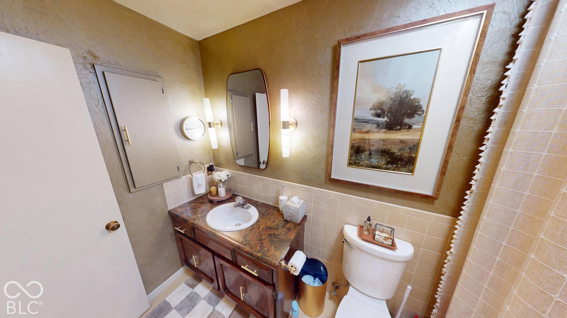 201 Bluffs Circle, Noblesville, IN 46062 Vanity with an integrated sink and brown countertop, wall-mounted light fixtures, and a toilet