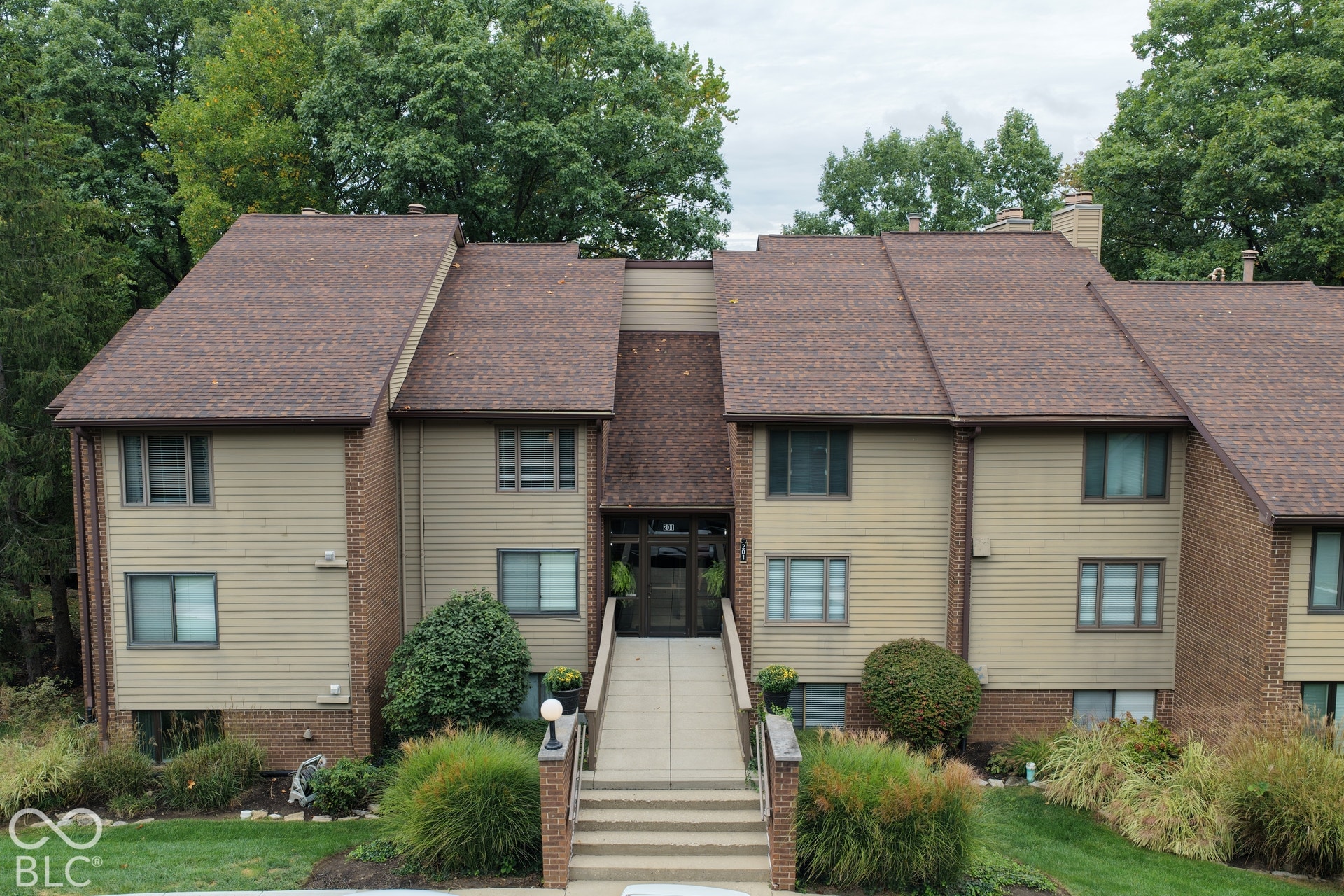 201 Bluffs Circle, Noblesville, IN 46062 Multi-level residential building featuring a prominent central entrance and brick detailing
