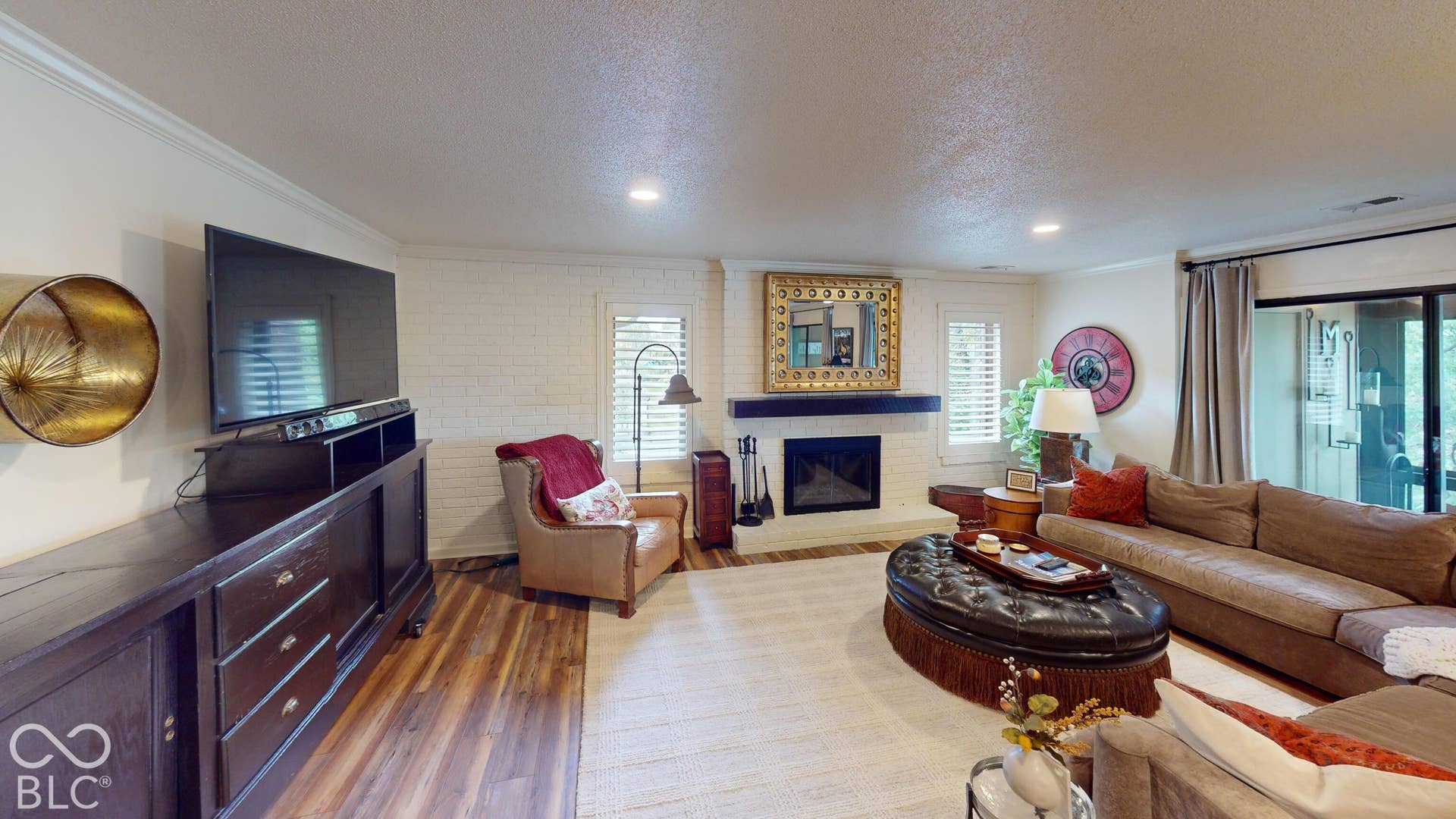 201 Bluffs Circle, Noblesville, IN 46062 Fireplace with a dark wood mantel and white brick surround