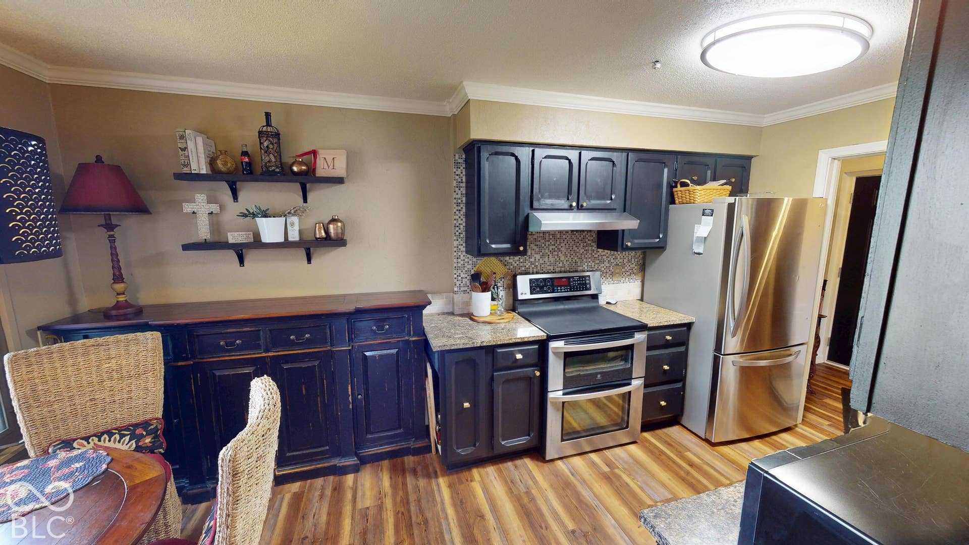 201 Bluffs Circle, Noblesville, IN 46062 Built-in cabinetry with stainless steel appliances, wood-finish flooring, granite countertops, and ceiling-mounted lighting