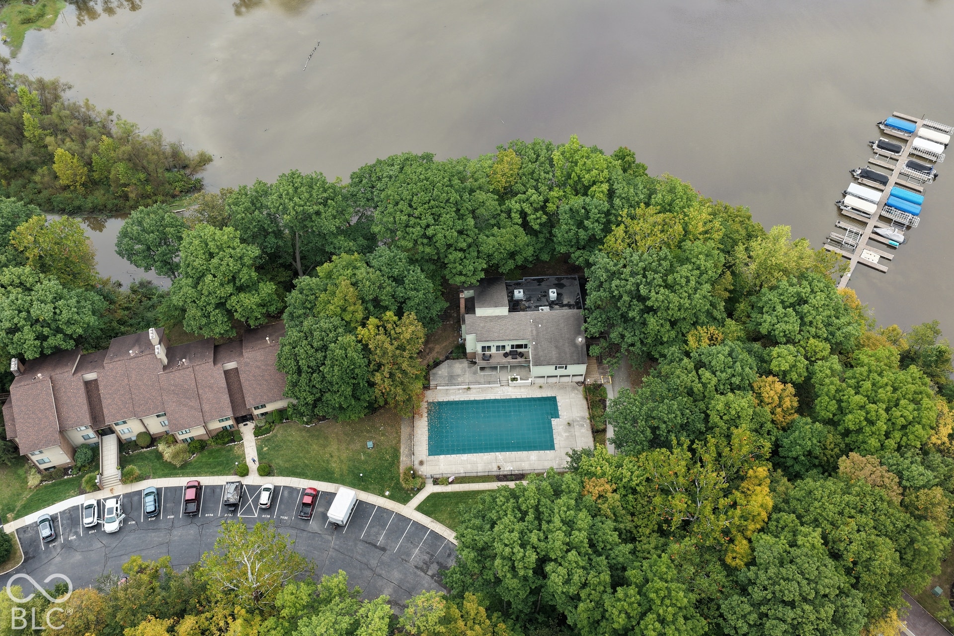 201 Bluffs Circle, Noblesville, IN 46062 Waterfront property featuring a private boat dock, a rectangular swimming pool, and mature trees
