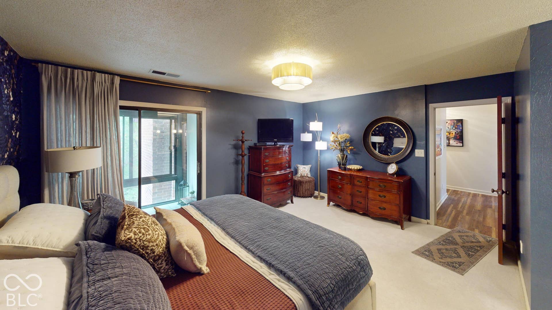 201 Bluffs Circle, Noblesville, IN 46062 BEDROOM #1 | *Primary Bedroom & bathroom & suite | Recessed ceiling light fixture, sliding glass door, wall-to-wall carpeting, and wood-finish flooring