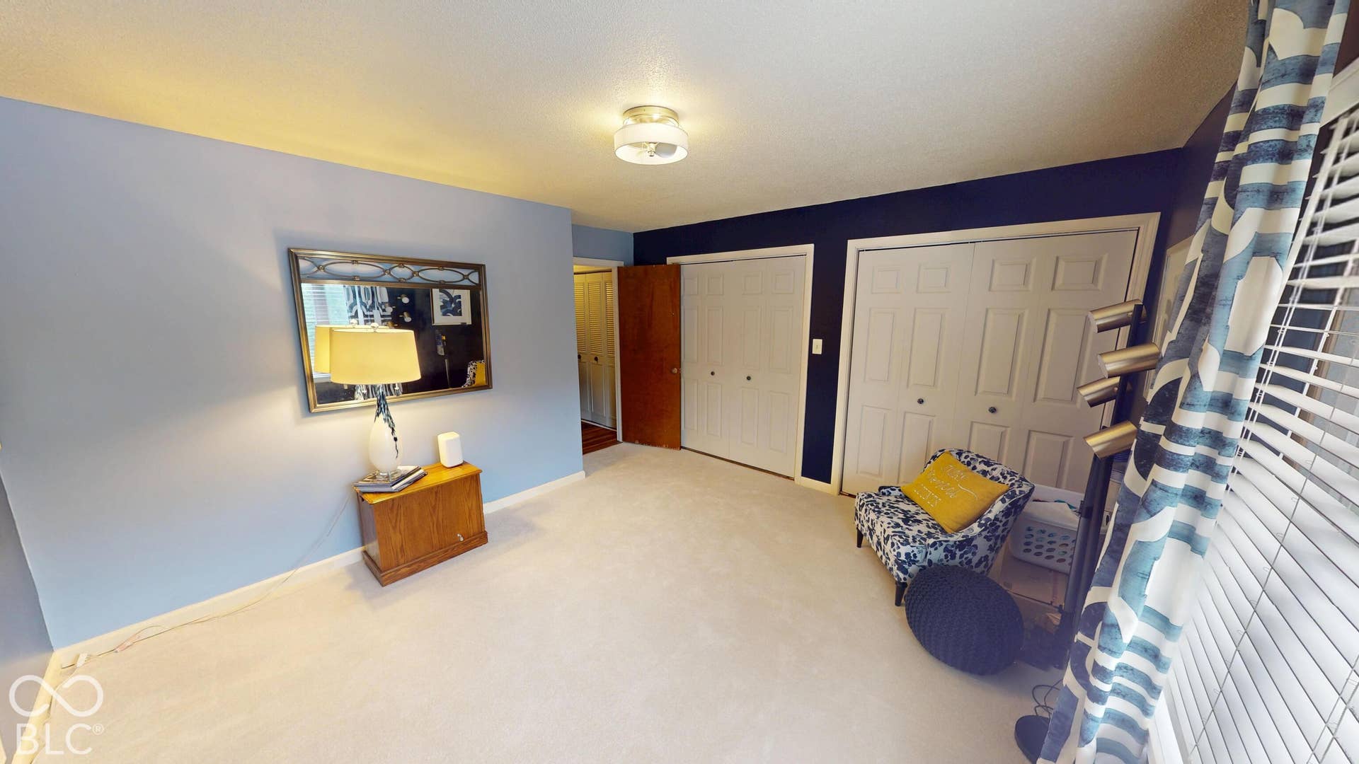 201 Bluffs Circle, Noblesville, IN 46062 BEDROOM #2 | Light-colored carpeting, two paneled closet doors, and a flush-mount ceiling light fixture