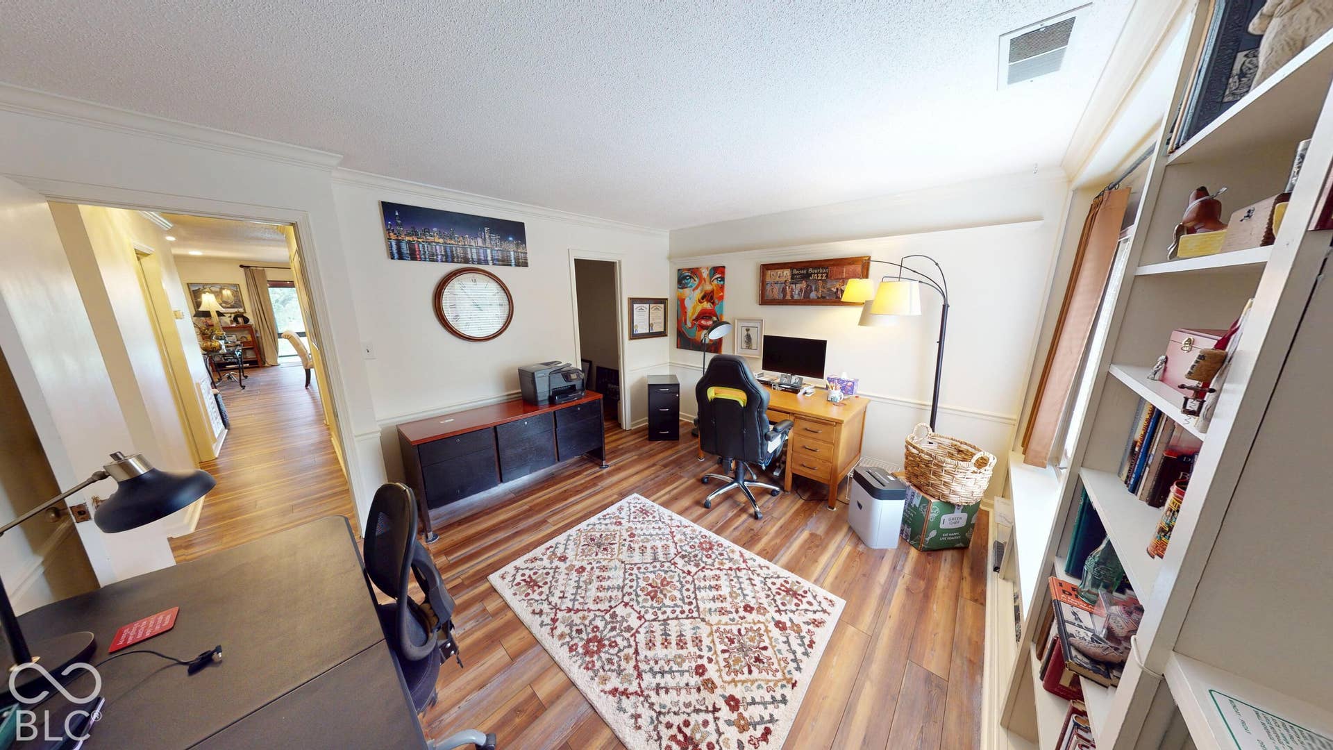 201 Bluffs Circle, Noblesville, IN 46062 BEDROOM #3 | Wood-finish flooring throughout, crown molding, built-in shelving, and warm wall tones