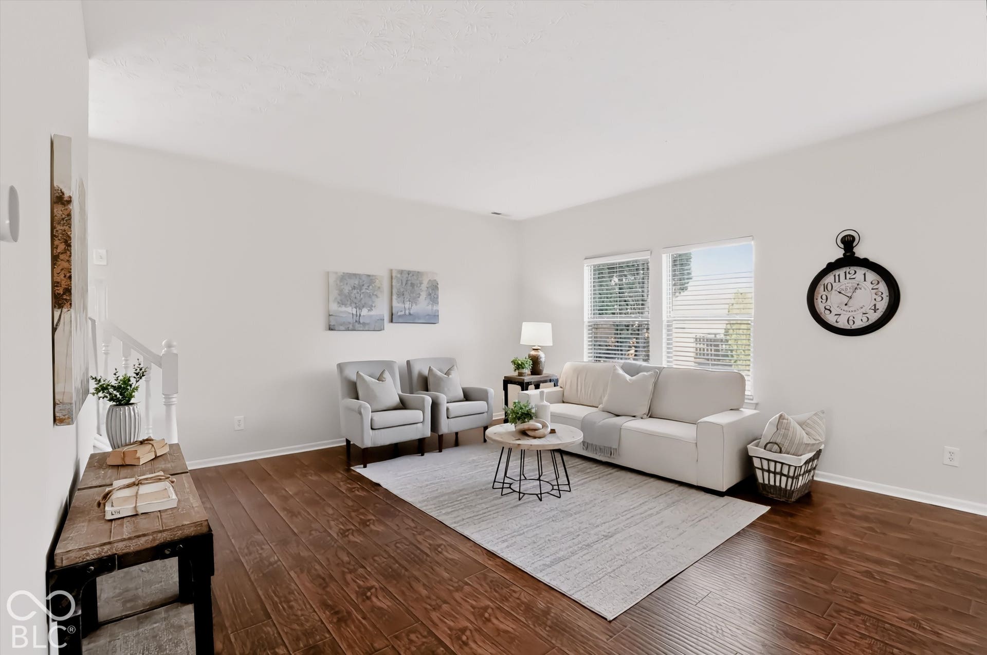 The family room is open to the kitchen.  Notice the natural lighting shining through and freshly painted walls.