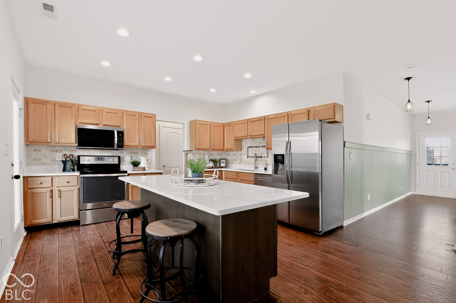The sellers used the new kitchen island for daily dining and loved the extra storage below it. Notice the new accent wall.