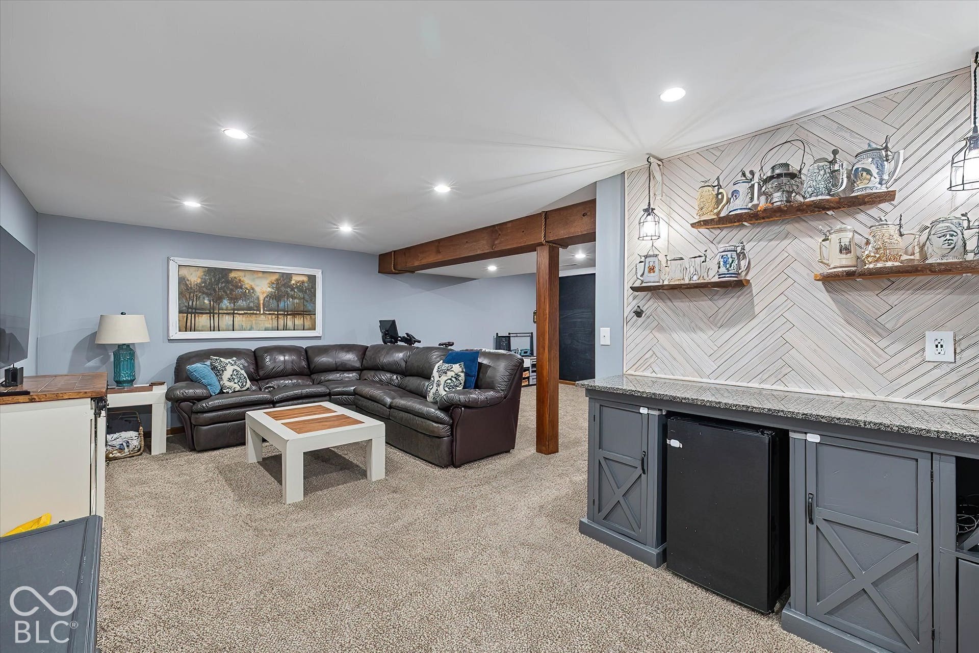 More entertainment space in basement- accent wall w/ cabinet / counter space + bev fridge