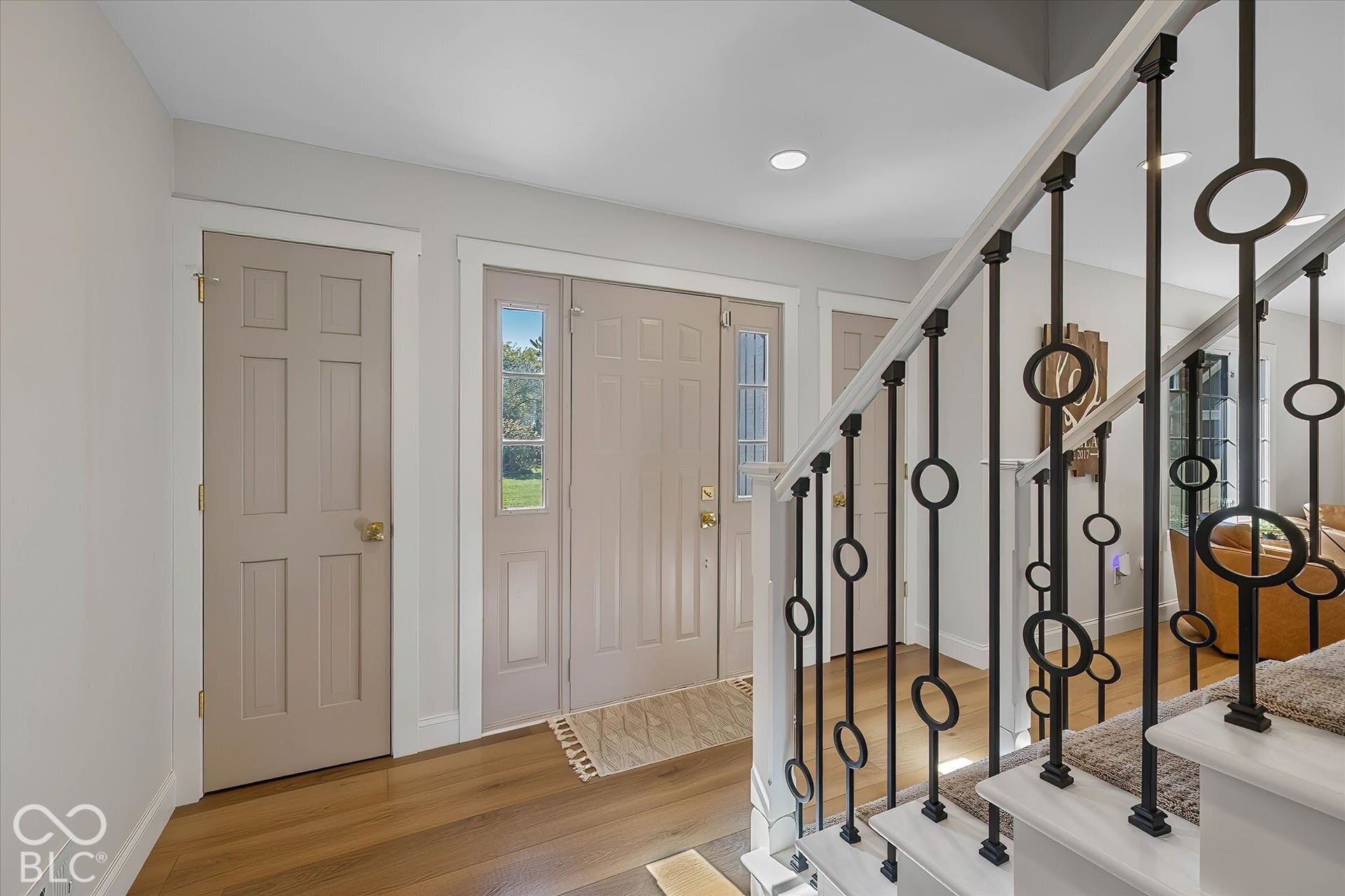 Entry w/ newer  LVP flooring, stair railing. Light and Bright!