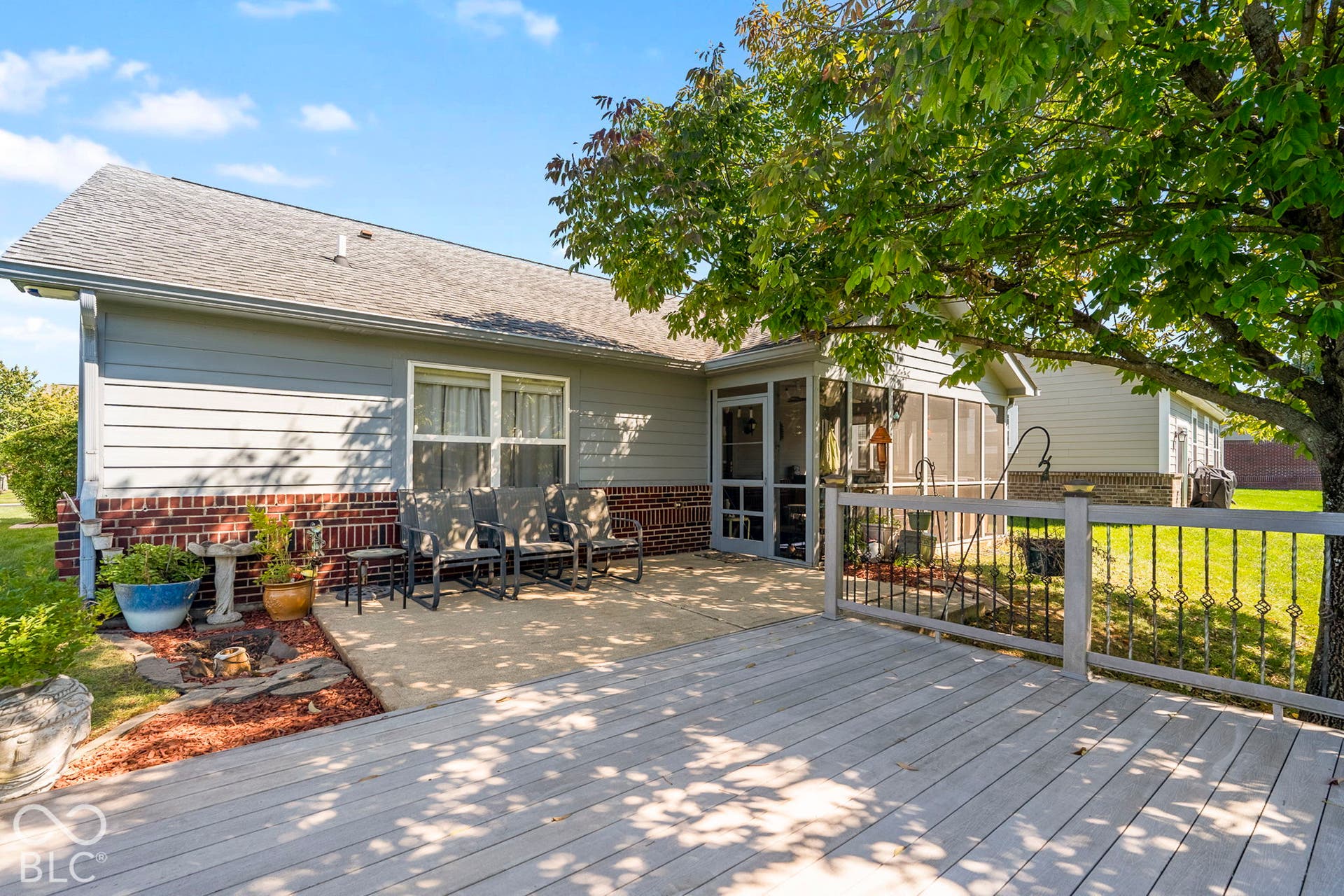 Wood-finish deck with a painted railing and wrought iron accents