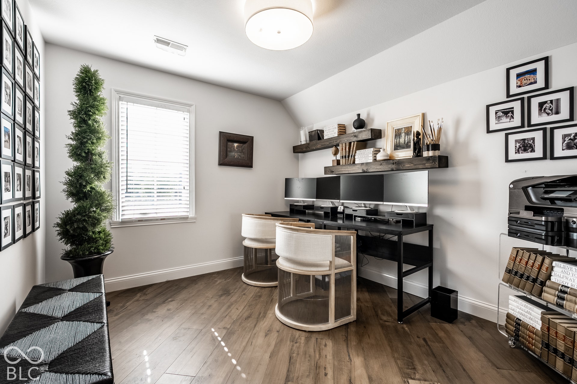 This Bedroom is currently being used as an Oficce with Wood-finish flooring throughout