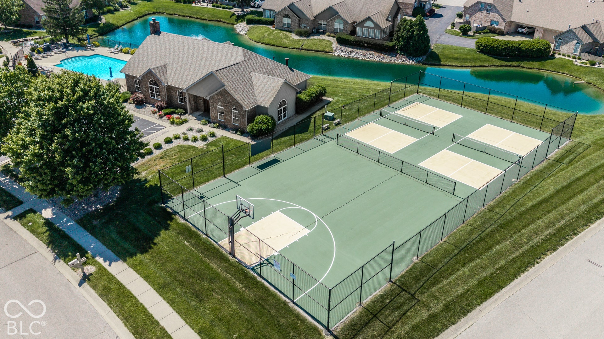 Recreational basketball court, multiple pickleball courts, community swimming pool, and pond features