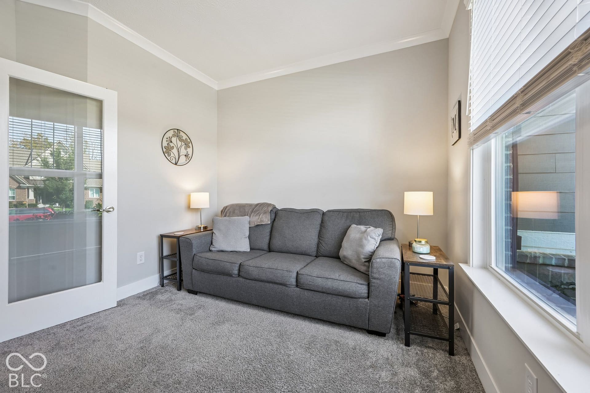 Recessed lighting, crown molding, a window with blinds, and glass-paneled interior door