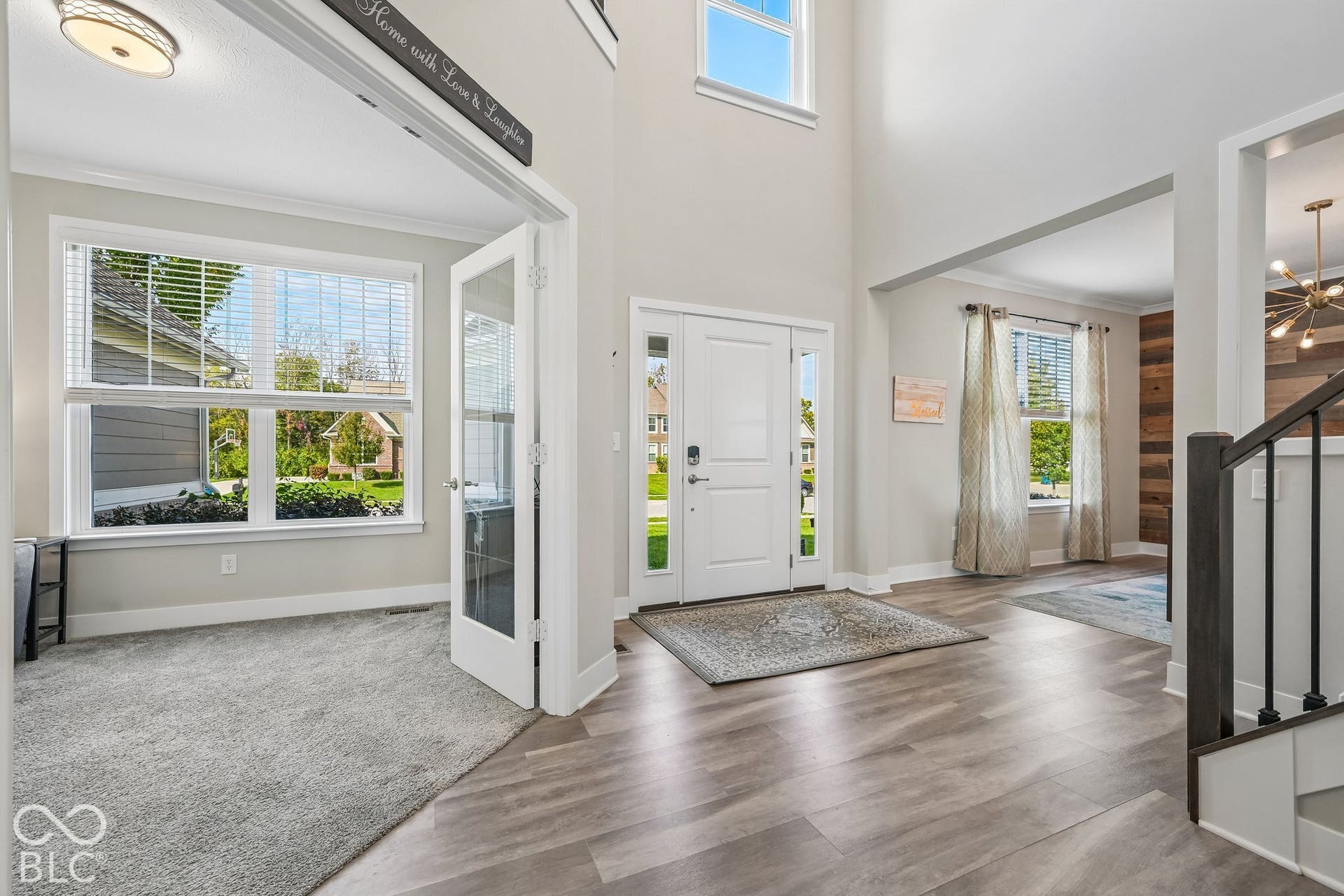 Two-story foyer with wood-finish flooring
