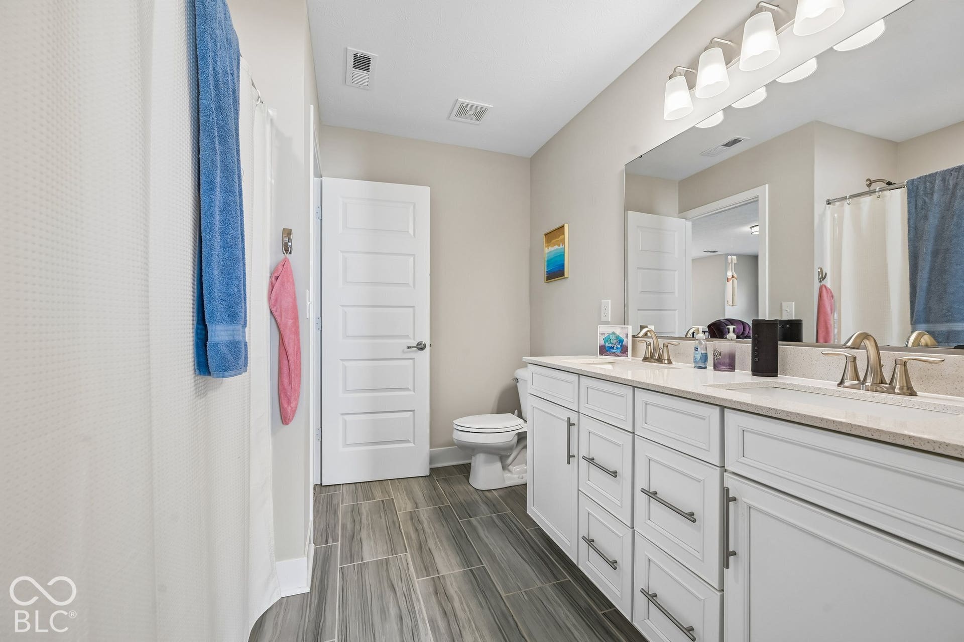 Dual vanity with light-toned countertops and undermount sinks