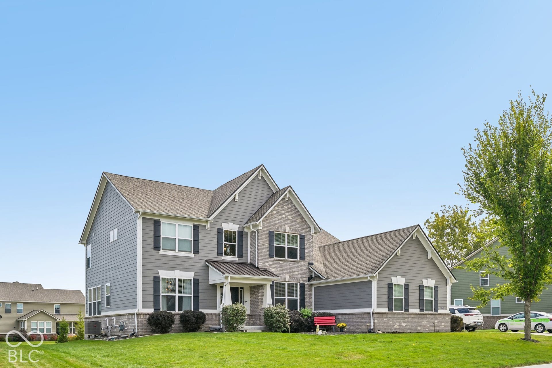 Two-story residence featuring a combination of gray siding and brick facade