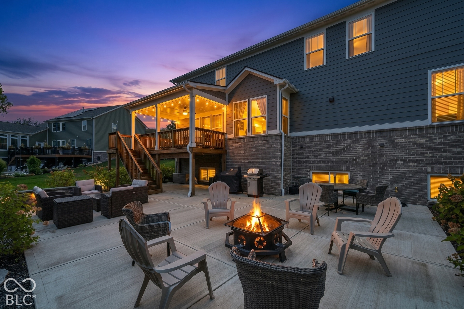Expansive concrete patio with a central fire pit