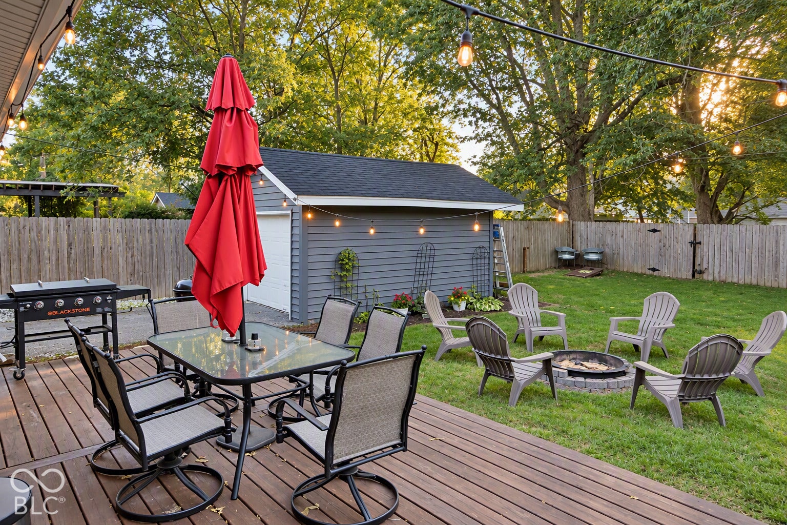 Expansive wood-finish deck with string lighting