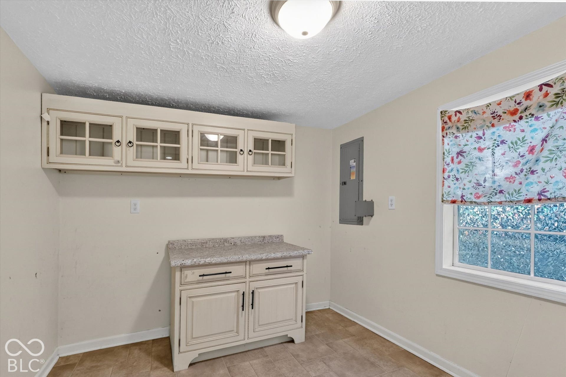 8404 Union Chapel Road, Indianapolis, IN 46240 Built-in storage cabinetry, ideal pantry space, lower cabinet with a solid surface countertop, vinyl flooring