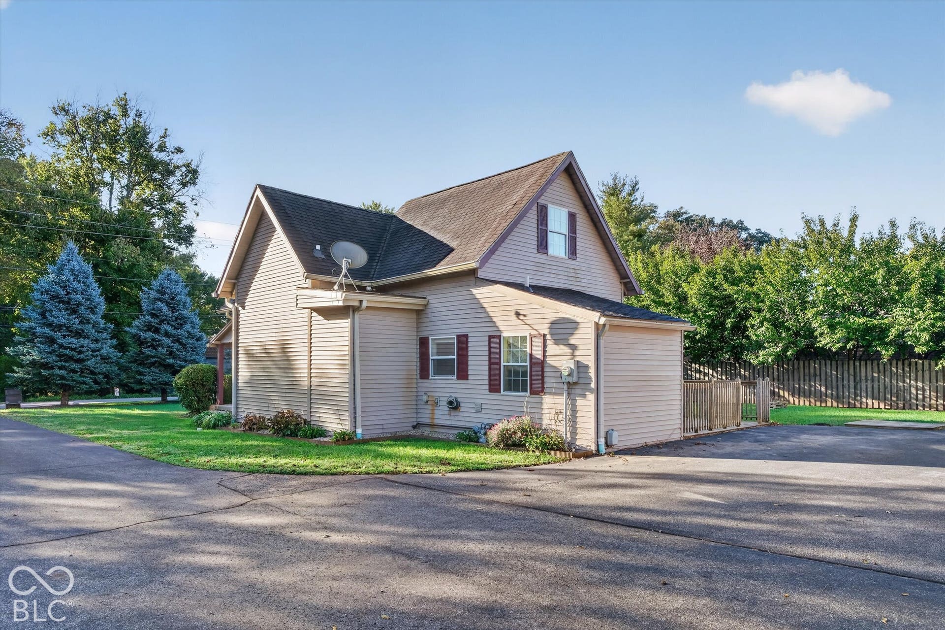 8404 Union Chapel Road, Indianapolis, IN 46240 Two-story residence featuring light-colored vinyl siding, dark shingle roofing, and contrasting red shutters