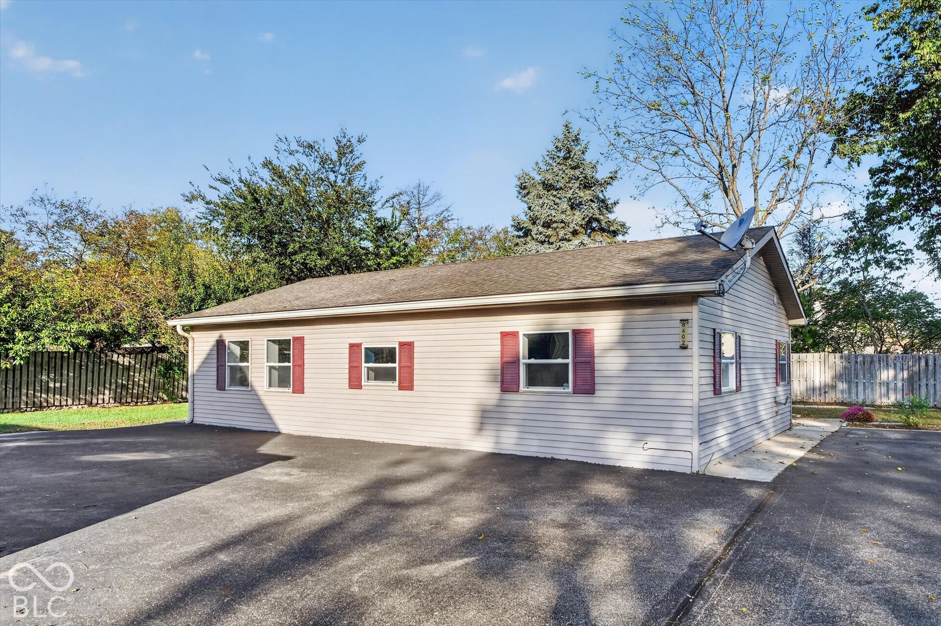 8404 Union Chapel Road, Indianapolis, IN 46240 Siding exterior with multiple windows featuring decorative shutters, asphalt roofing, and paved driveway