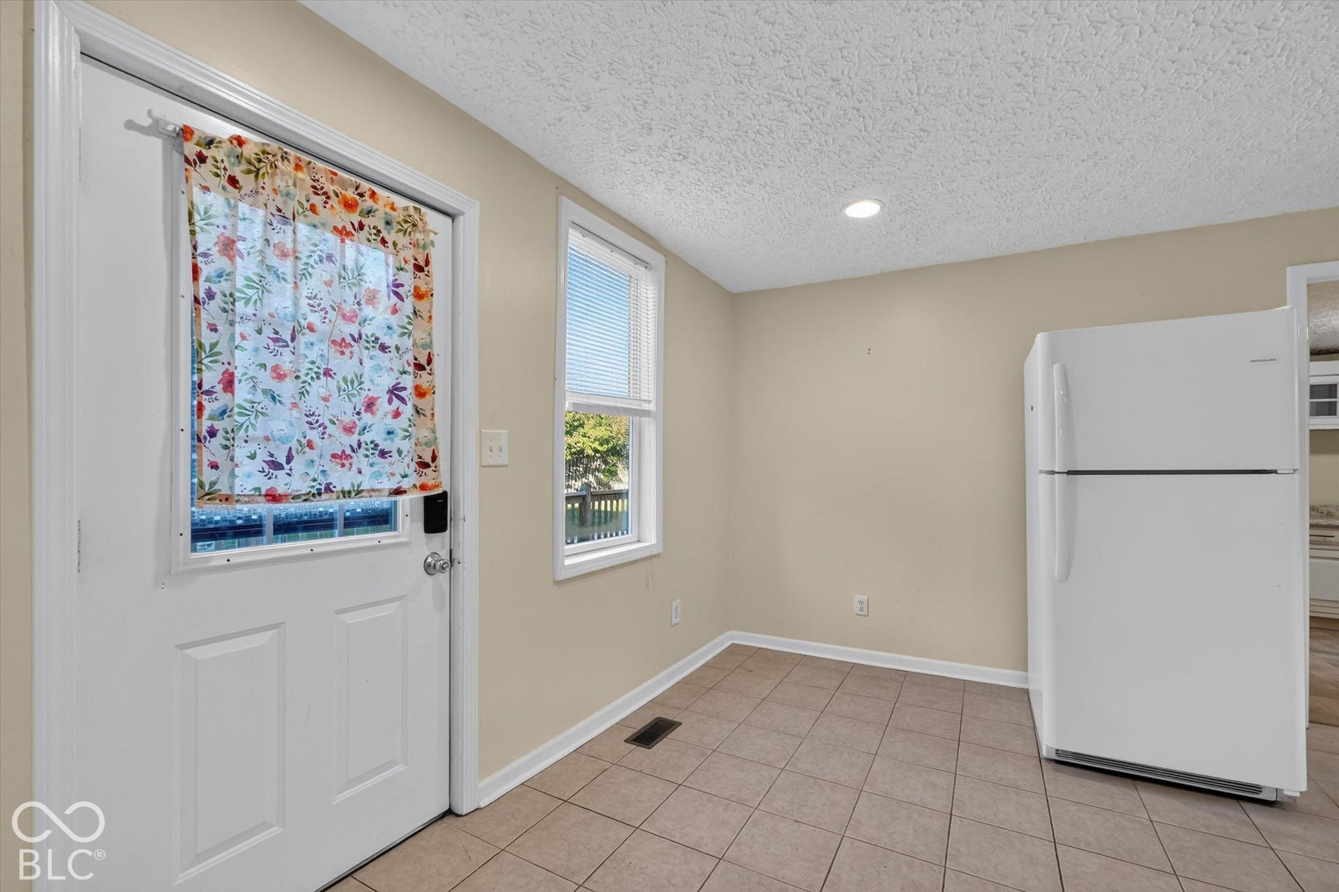 8404 Union Chapel Road, Indianapolis, IN 46240 Tile flooring with a side entry door to the wood deck and firepit