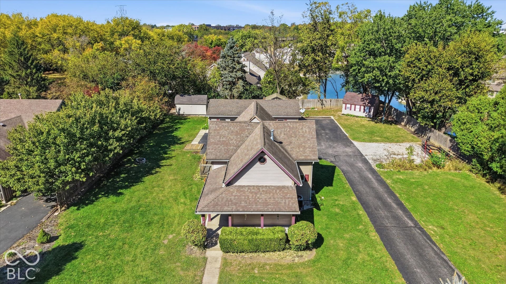 8404 Union Chapel Road, Indianapolis, IN 46240 Expansive paved driveway leading to the property, surrounded by mature trees and lush green lawn
