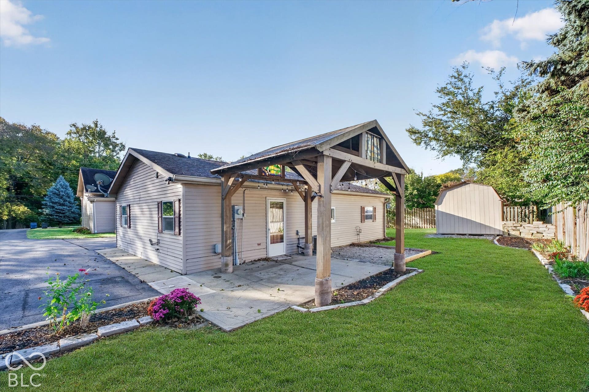 8404 Union Chapel Road, Indianapolis, IN 46240 Manicured lawn, concrete patio, wood pergola, and a storage shed