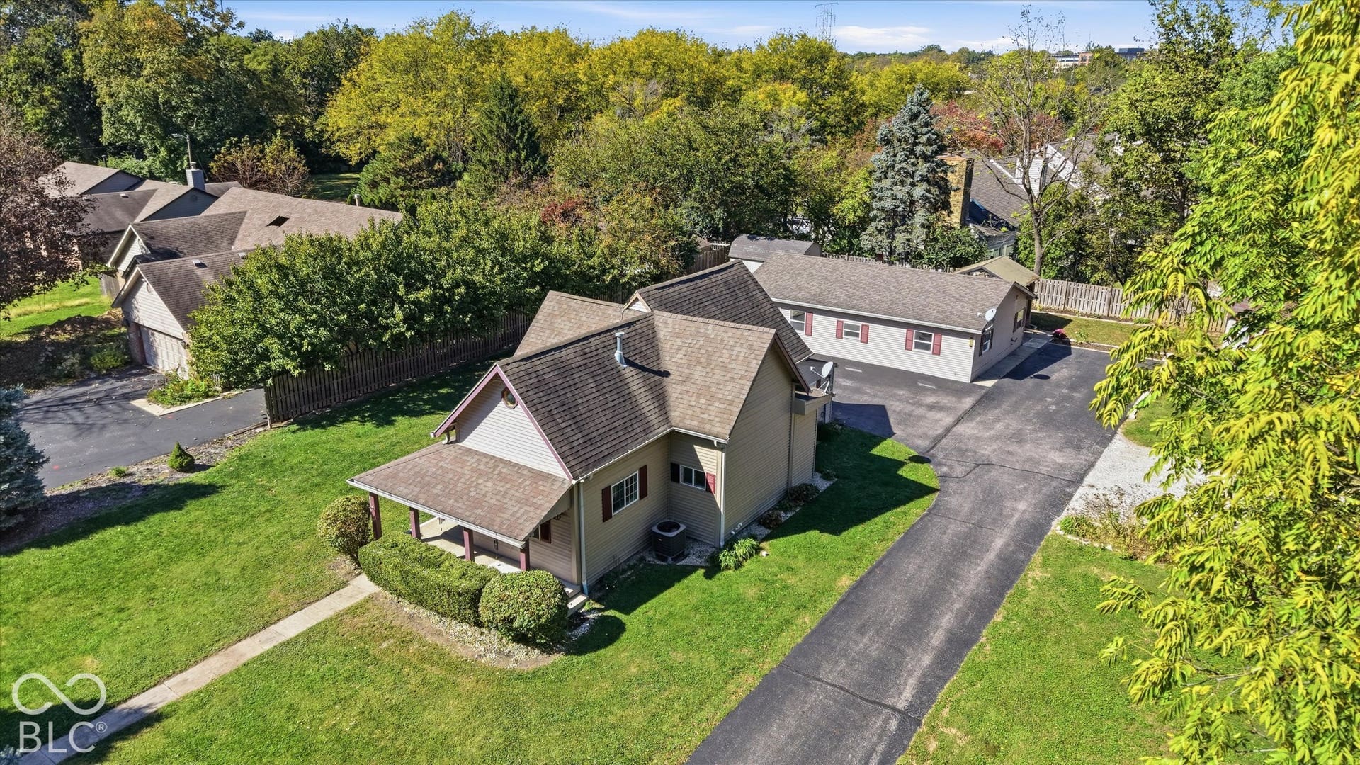 8404 Union Chapel Road, Indianapolis, IN 46240 Expansive green lawn with mature trees and a paved driveway leading to the residence
