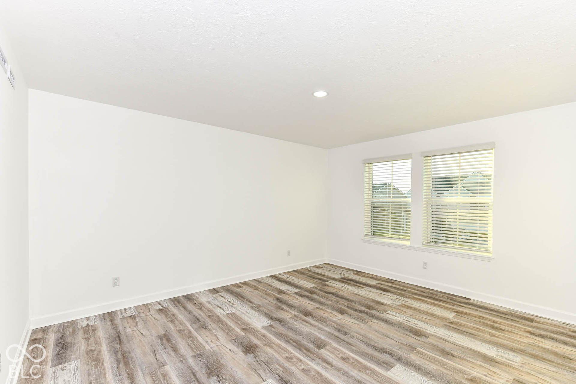 Neutral wall tones, wood-finish flooring, and white trim