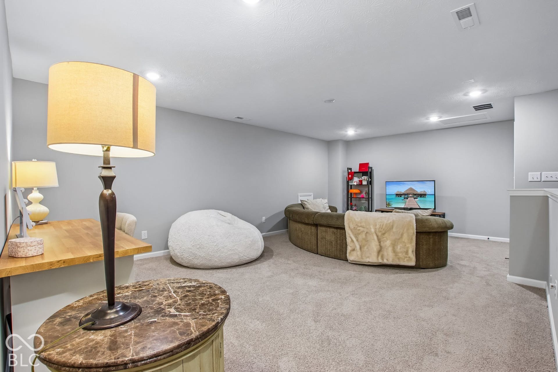 Carpeted flooring, recessed lighting, and a built-in wood-finish desk