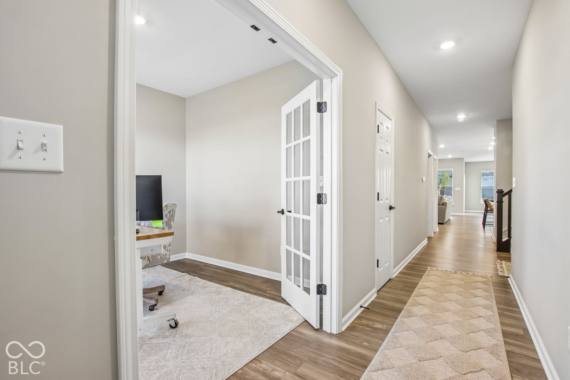 Hardwood-style flooring throughout the hall and room