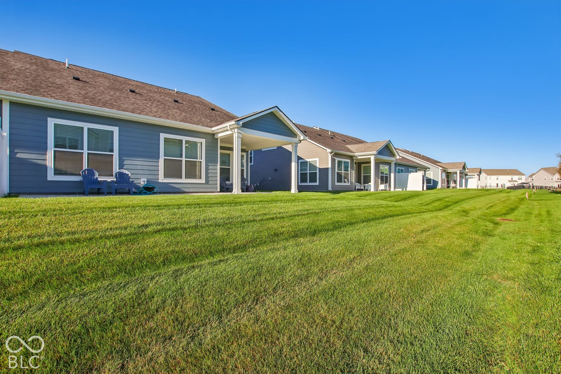 Expansive green lawn extending from the property