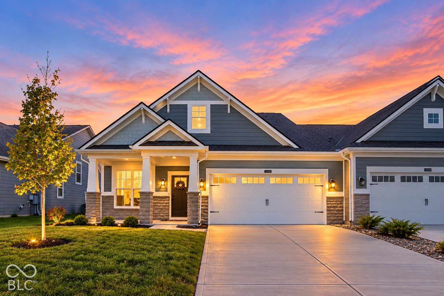 Craftsman-style exterior featuring a covered entry, stone veneer accents, and a two-car garage