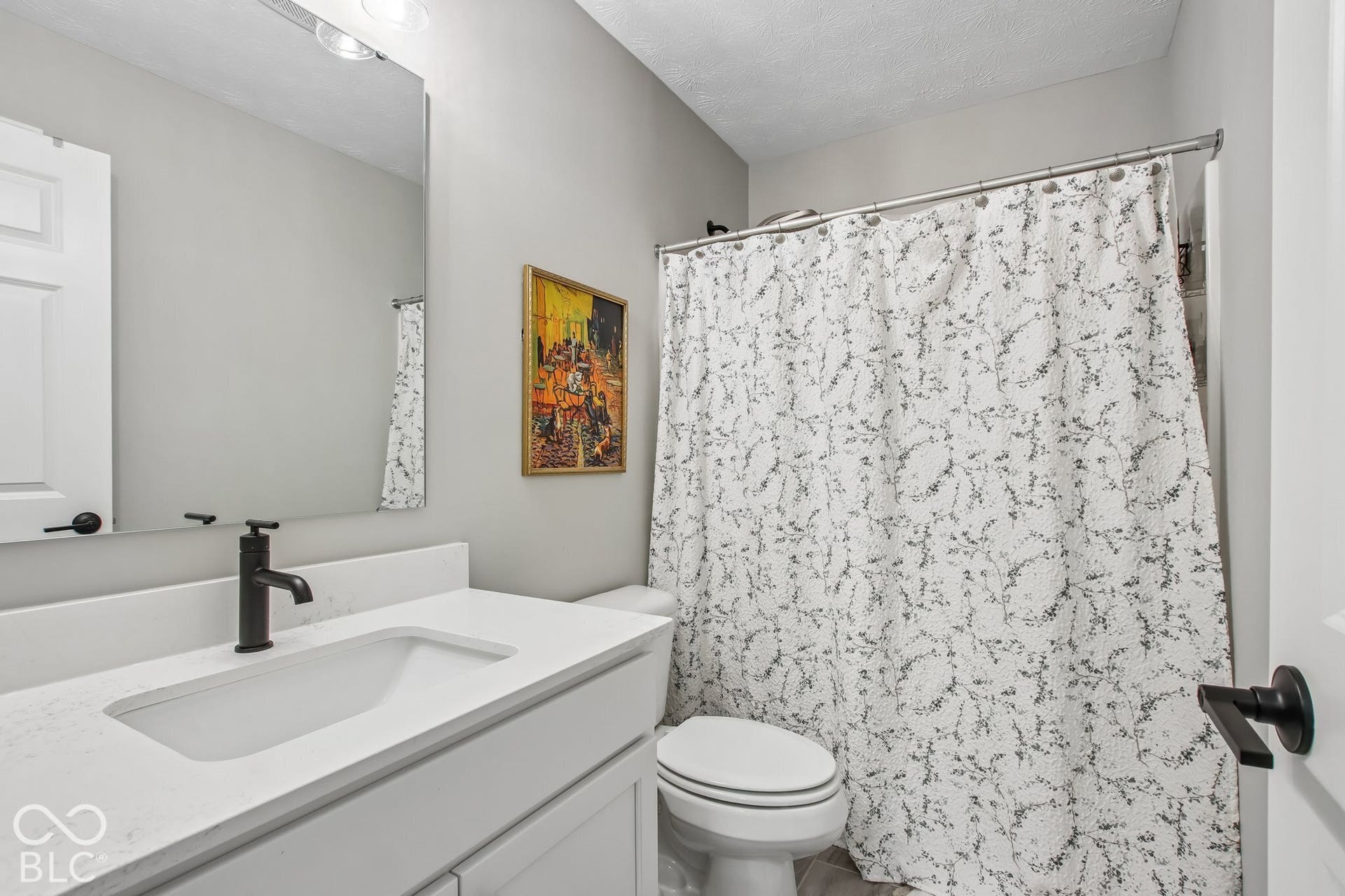Vanity with integrated sink, matte black faucet, and white countertop