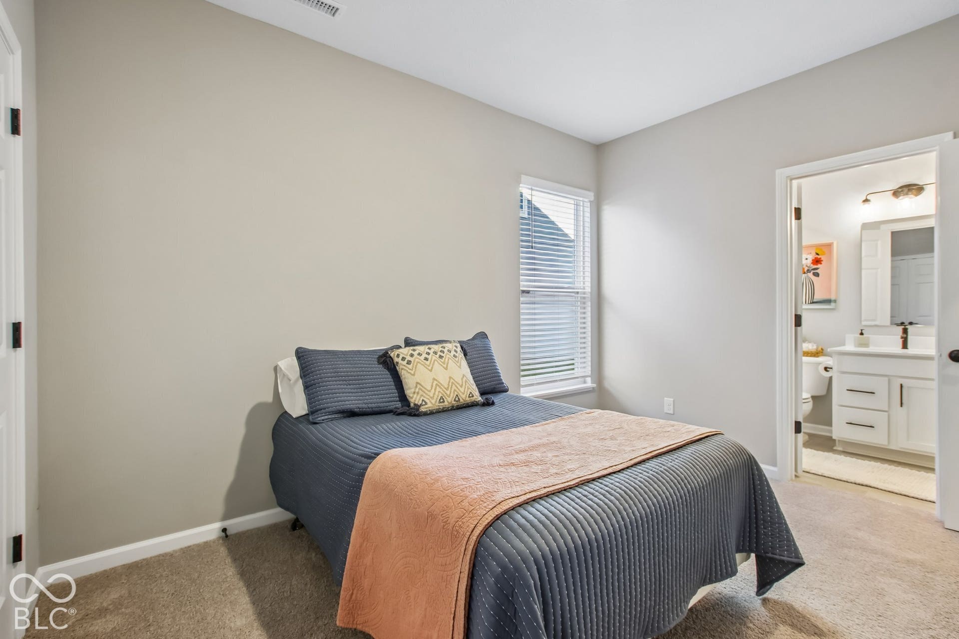 Bedroom featuring neutral wall colors, carpet flooring, and a window with blinds