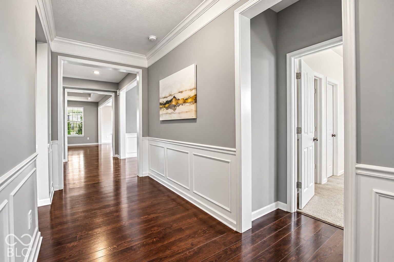 Hardwood-finish flooring, wainscoting, crown molding, and recessed lighting