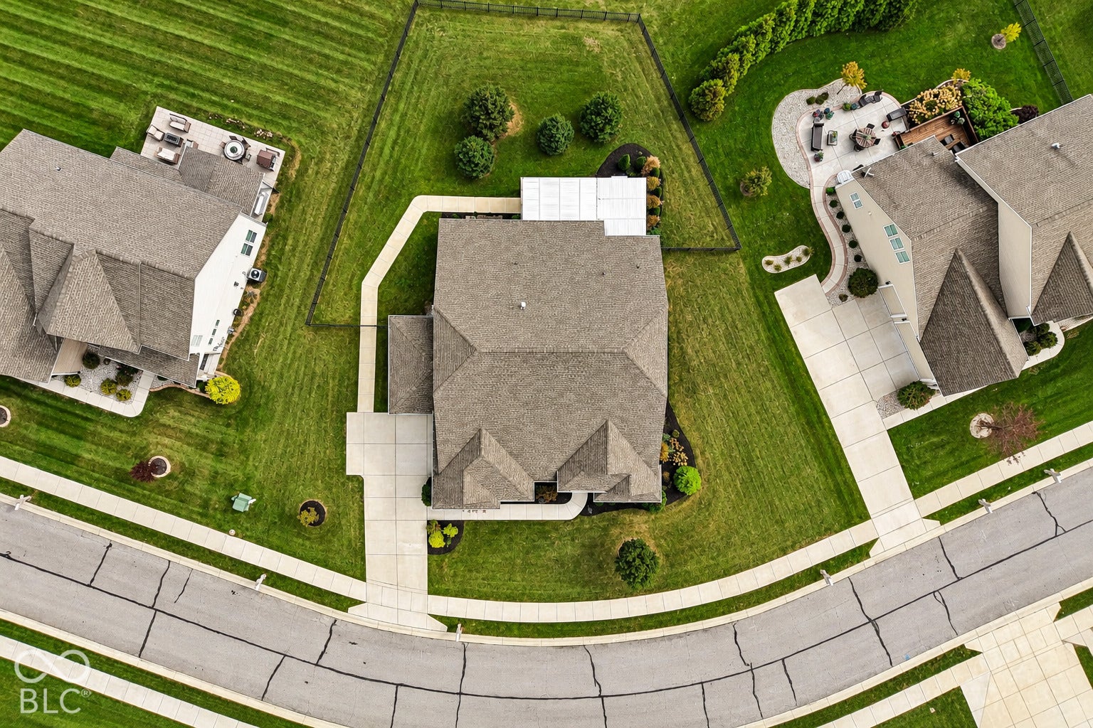 Expansive green lawn surrounds the property