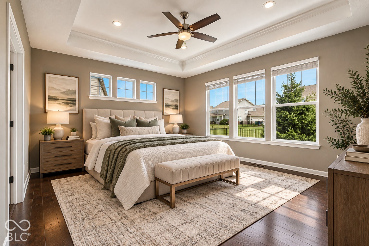 Tray ceiling with recessed lighting and a ceiling fan, dark wood-finish flooring, and multiple large windows with white trim
