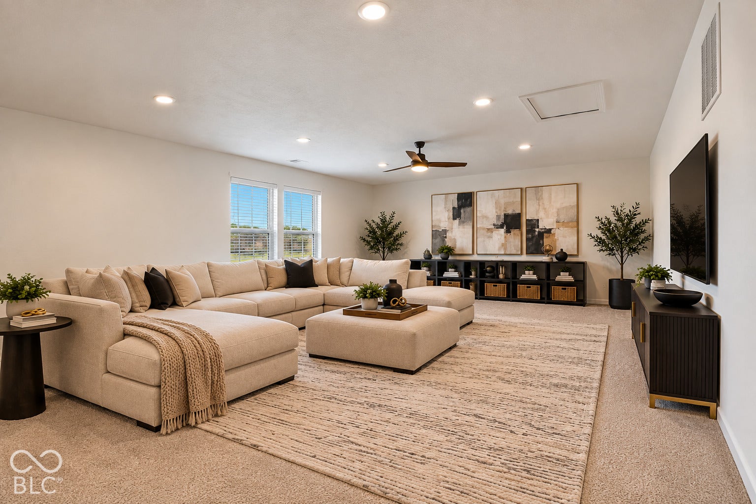 Spacious room featuring neutral carpeting, recessed lighting, and a ceiling fan