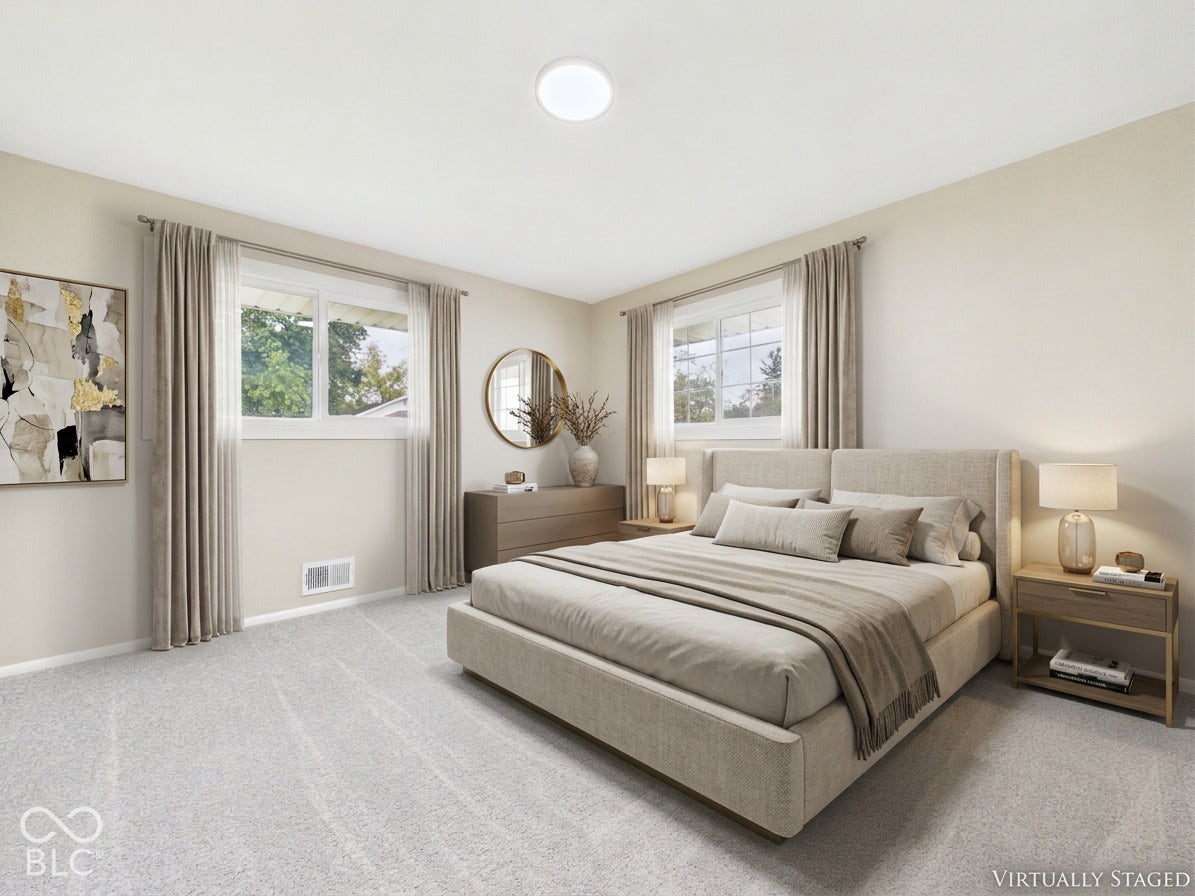 Plush carpet flooring, neutral wall tones, two windows with white frames, and a flush-mount ceiling light