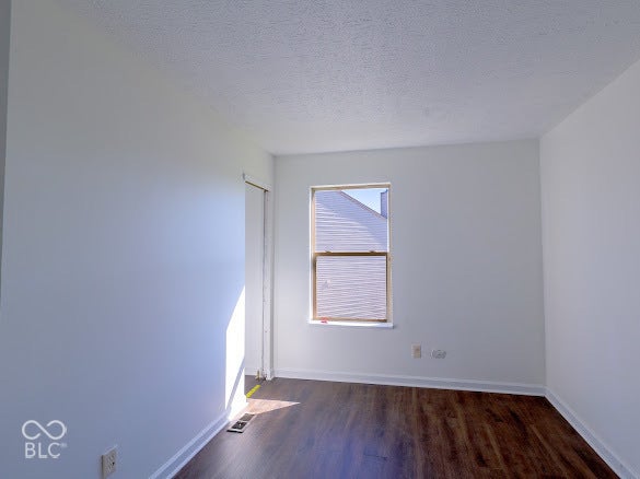 Wood-finish flooring with white baseboards