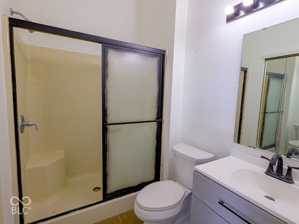 Shower enclosure with sliding frosted glass doors, integrated shower seat, and brushed nickel fixtures