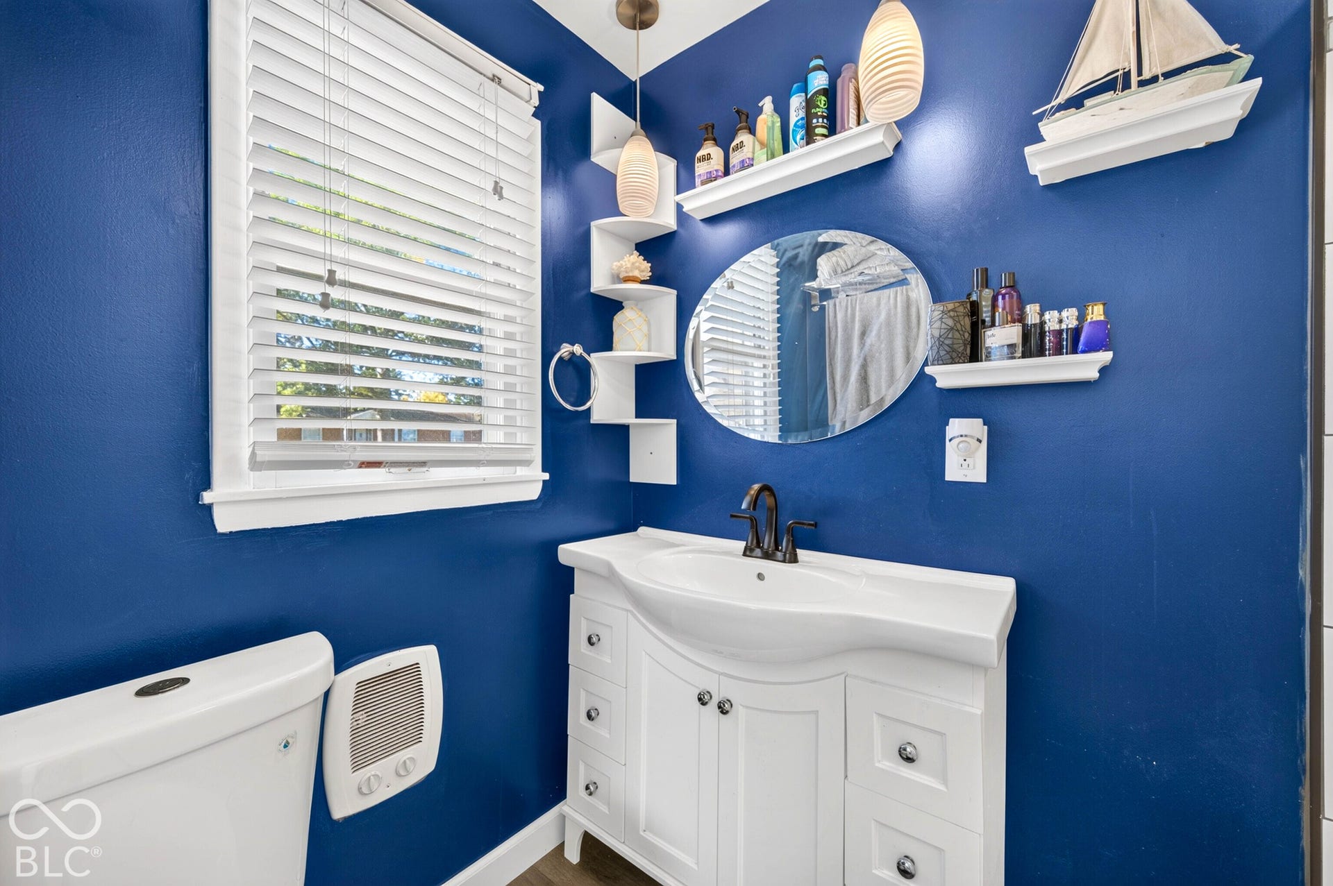 White vanity with an integrated sink and dark bronze faucet