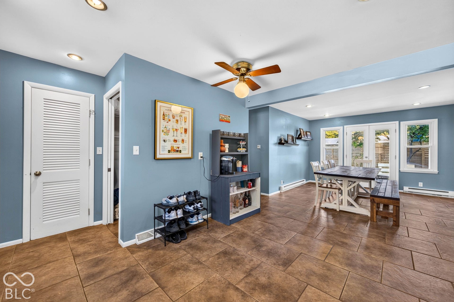 Expansive ceramic tile flooring throughout, recessed lighting, and a ceiling fan with integrated lighting