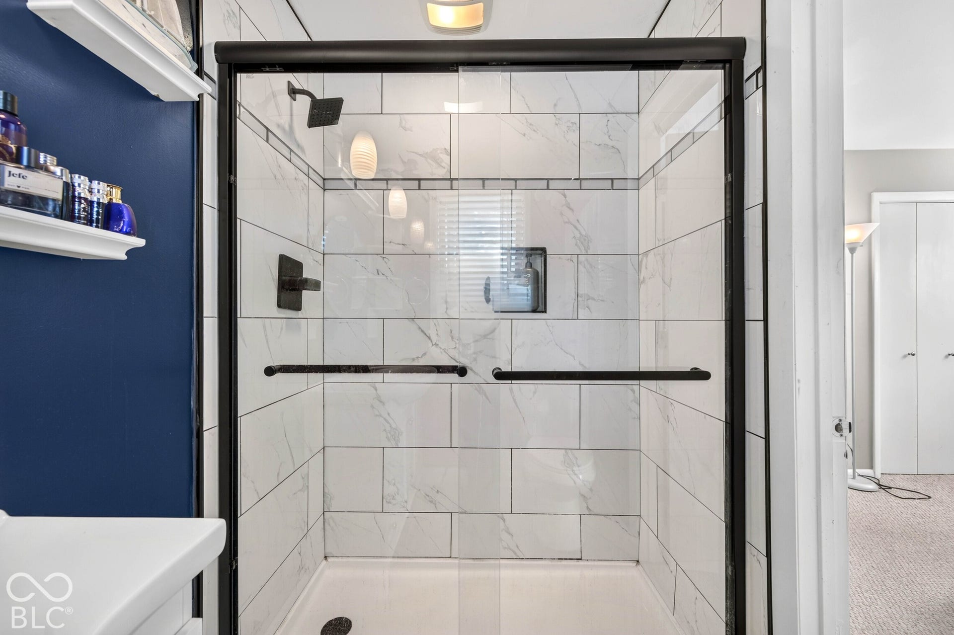 Shower enclosure with a black frame and clear glass panels