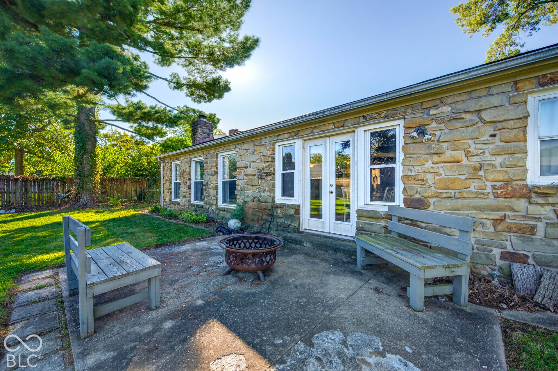 Stone exterior featuring multiple windows and French doors