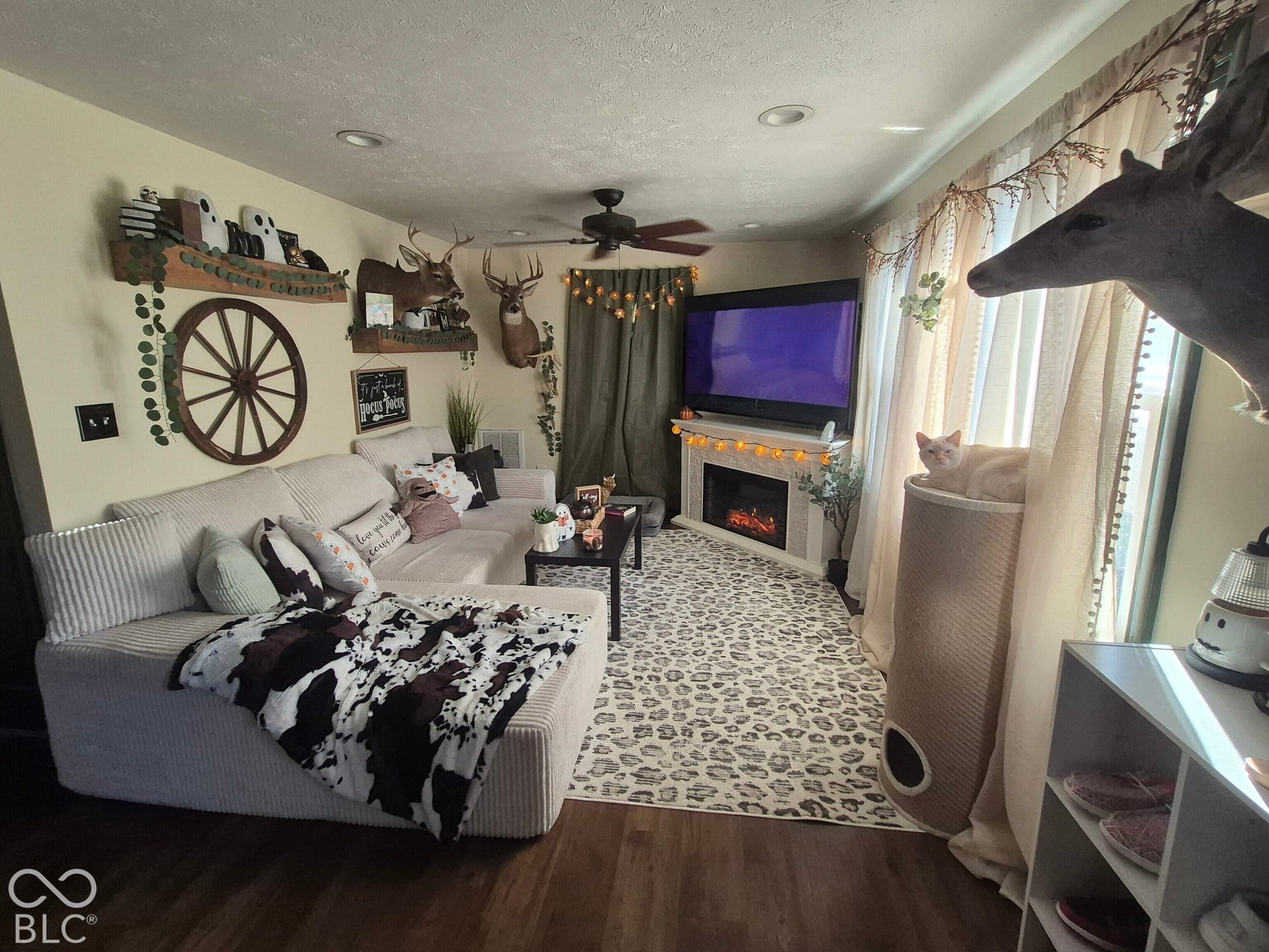 Recessed lighting, wood-finish flooring, ceiling fan, and an electric fireplace feature